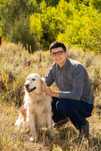 picture of a young man wearing glasses with his dog