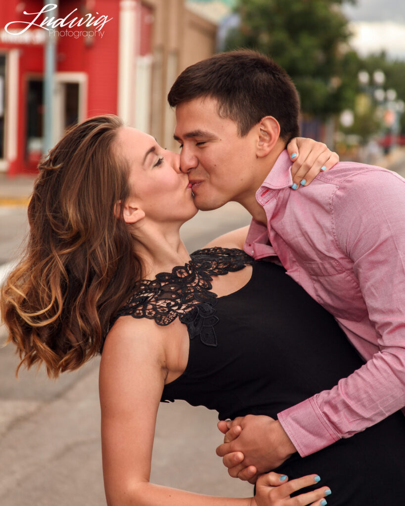 couple kissing in downtown Laramie Wyoming during a photoshoot