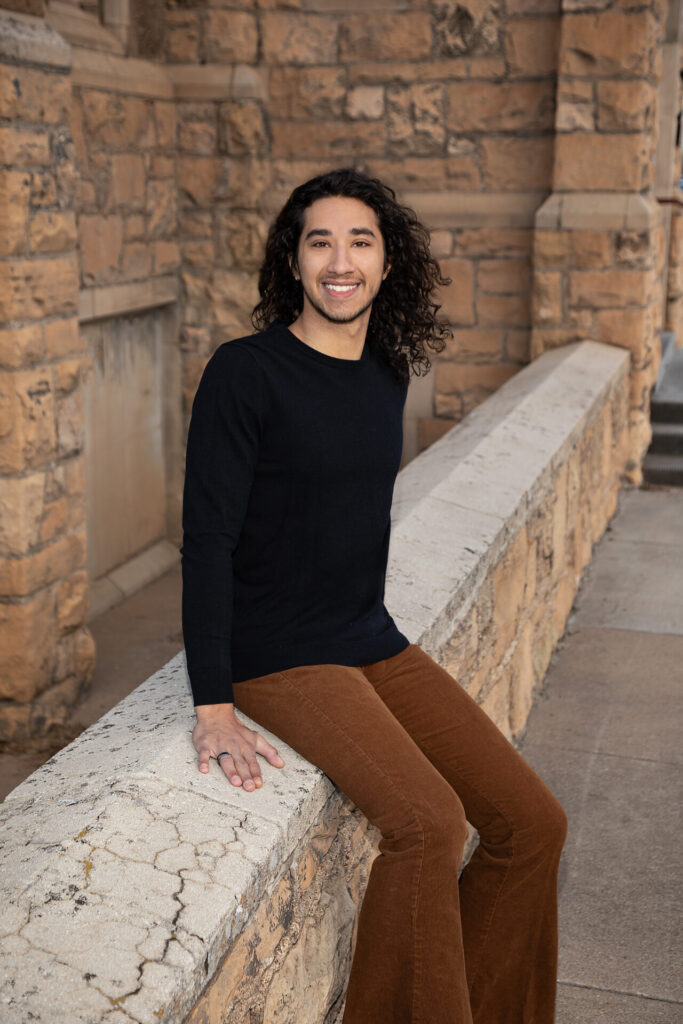 a young man poses for the camera at the historic St Matthews Cathedral in laramie wyoming. college seniors photography photographer